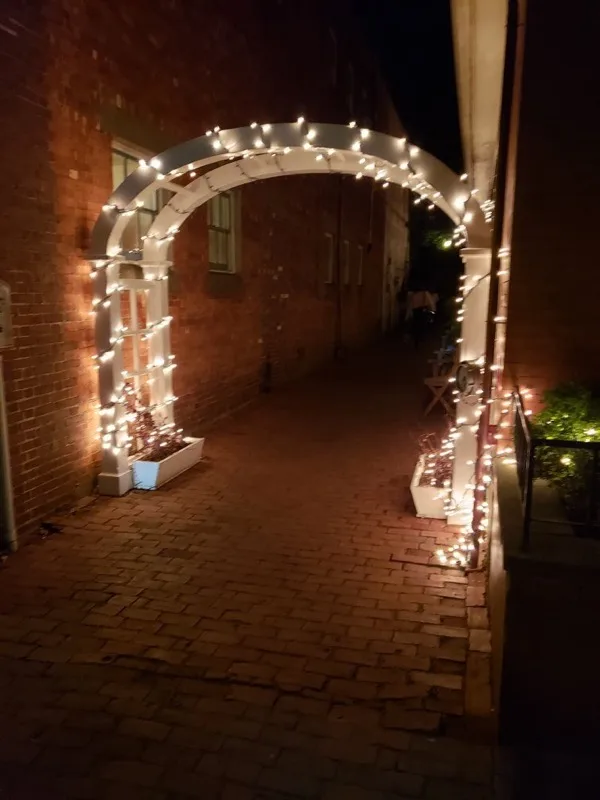 Lit arch entrance leading to or, The Whale back patio